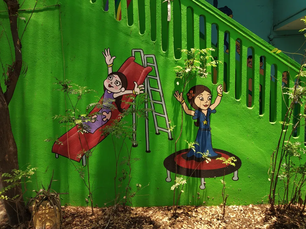 Hand-painted playground mural by Vamshi Arts